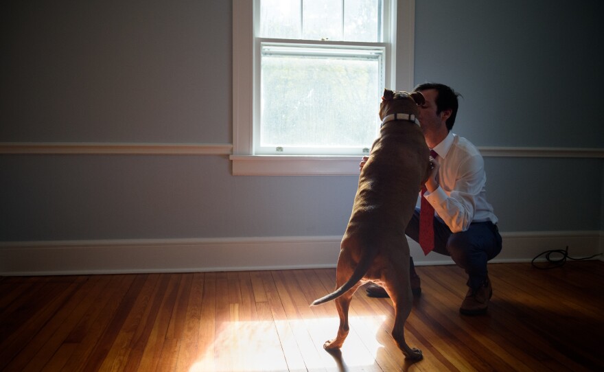 Burke with his emotional support dog, Rosie, in his home in Weston, Conn.