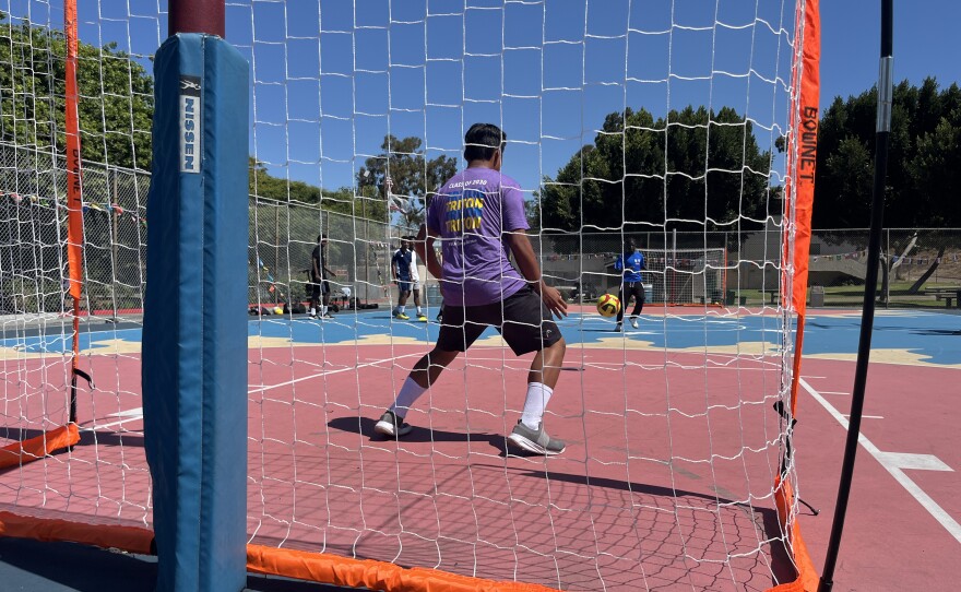 Youth soccer players attempt to score on goal at Colina Del Sol Park's basketball courts, July 10, 2025.