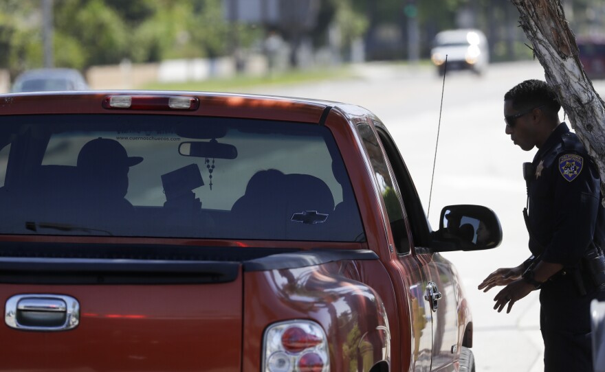 File photo of a California Highway Patrol officer stopping a motorist who was suspected of speeding along Interstate 5 freeway on April 23, 2020, in Anaheim, Calif.