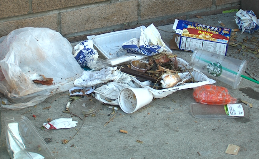 Trash litters the side of a bus stop in Hillcrest, April 3, 2017.