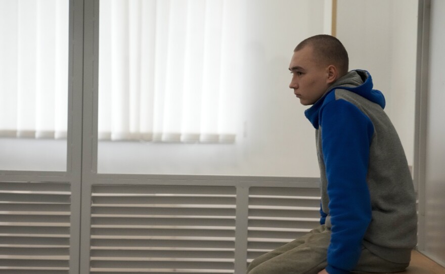 Russian Sgt. Vadim Shishimarin waits for the start of a court hearing in Kyiv, Ukraine, on Monday. Judges went on to sentence him to life in the first war crimes trial since Russia's full-scale invasion of Ukraine.
