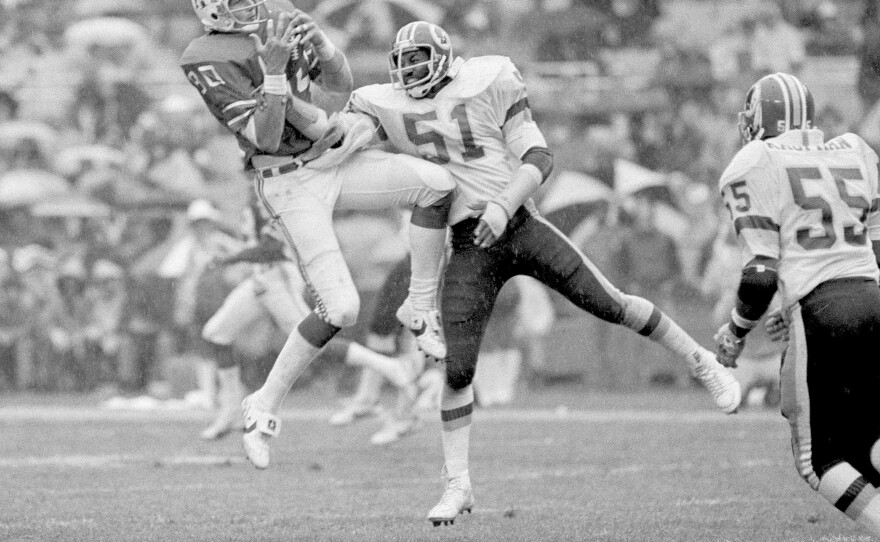 New England Patriot Don Hasselbeck fights to hold on to a pass as Washington Redskin Monte Coleman tries to shake the ball loose, Oct. 25, 1981.