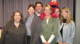These Days team and Elmo. From left, Maureen Cavanaugh, Angela Carone, Hank Crook, Natalie Walsh, Elmo, Rachel Ferguson, and Megan Burke.