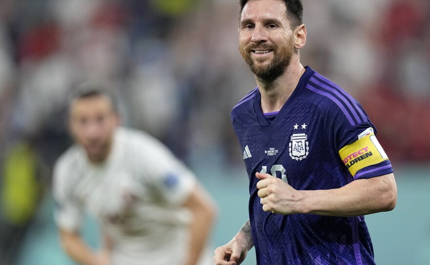 Argentina's Lionel Messi smiles during the World Cup group C soccer match between Poland and Argentina in Doha, Qatar, on Nov. 30, 2022.