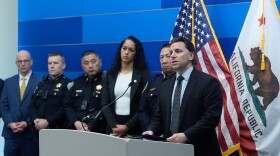 Matt Cobo, F.B.I. San Francisco Acting Special Agent in Charge ( right) speaks next to San Francisco Police Chief Derrick Lew (second from right) and San Francisco District Attorney Brooke Jenkins (third from right) during a news conference Monday, April 13, 2026, in San Francisco.