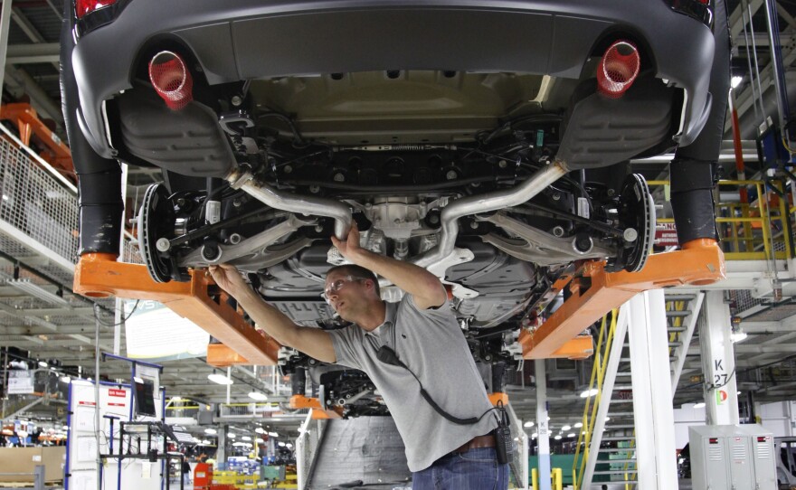 Jeff Caldwell, a chassis assembly line supervisor, checks a vehicle on the assembly line at the Chrysler Jefferson North Assembly plant in Detroit on May 8.