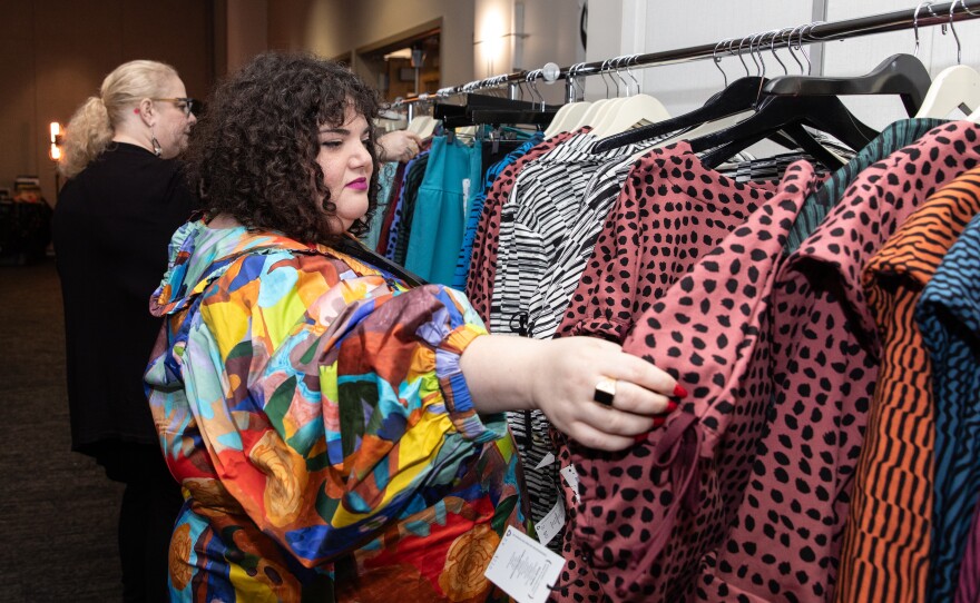Alexis Krase, owner of Plus BKLYN, looks through a rack of clothes of the brand Lobo Mau at Philly FatCon last month. Krase was also a speaker at the event, as part of the 'Fat & Fashionable' panel.