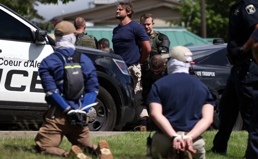 Law enforcement detains and arrest 31 members of the white nationalist group Patriot Front on suspicion of conspiracy to riot after they were removed from a U-Haul truck near the LGBTQ community's Pride in the Park event in Coeur d'Alene, Idaho, last June.