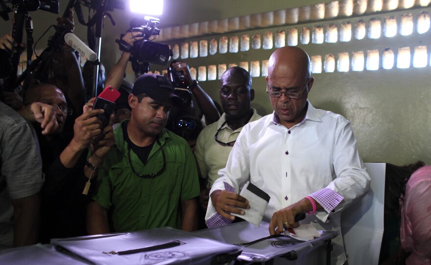 Haiti's President Michel Martelly casts his ballot during elections in the Petion-Ville suburb of Port-au-Prince, Haiti, Sunday. The country is holding the first-round presidential vote Sunday along with balloting for numerous legislative races and local offices.