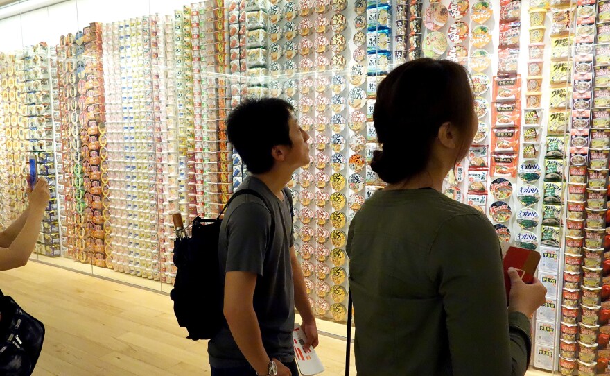 Visitors view a display of Cup Noodles packages from around the world.