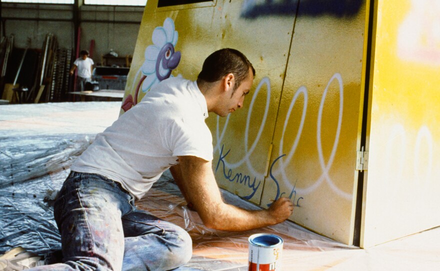 Kenny Scharf works on his painted swing ride for the original Luna Luna.
