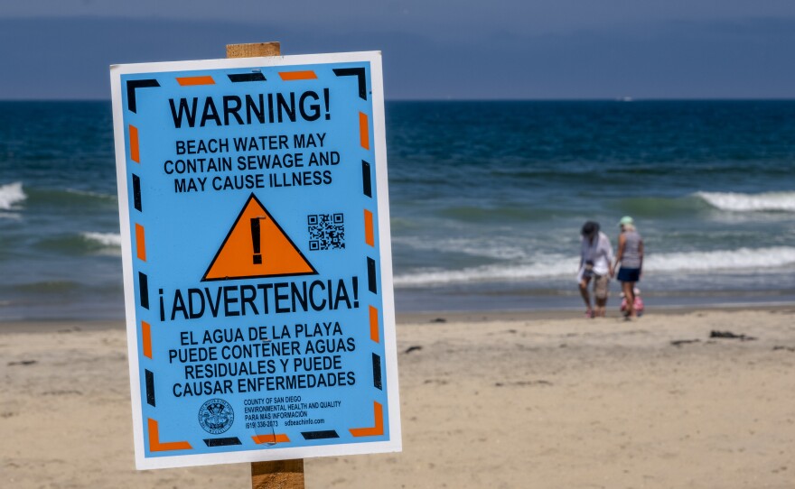 A sign warning people to stay out of the water is shown at Imperial Beach on July 18, 2023.