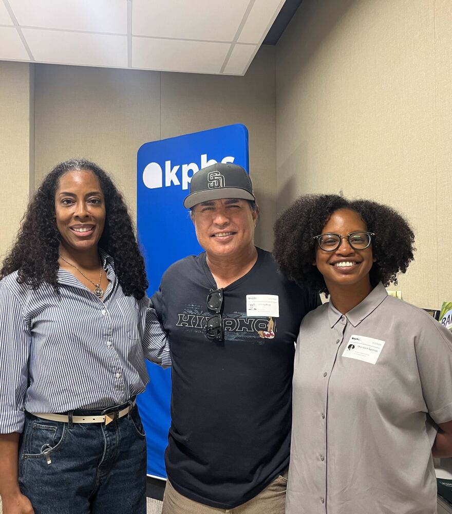 KPBS Midday Edition host Jade Hindmon (left) stands with Johnny Bear Contreras,  Eyaay Ahuun Foundation founder and Shanasia Sylman (right), graduate research fellow in the KPBS Midday Edition studio, Aug. 19, 2025.
