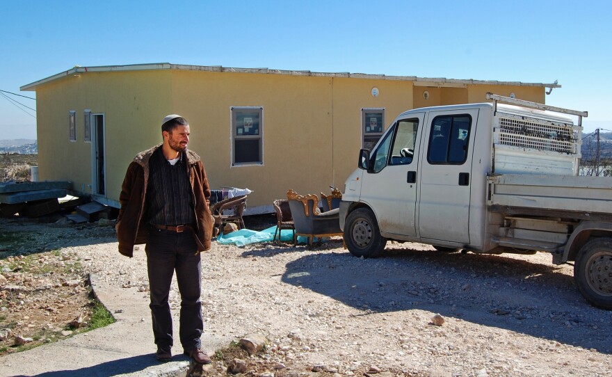 Jewish Israeli Nachum Pechenick stands outside his new house in the West Bank settlement of Kiryat Arba. If the area became part of an independent Palestinian state, Pechenick says he would like to stay and become a Palestinian citizen.