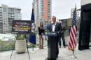 Rep. Scott Peters, D-San Diego, speaks at a media event highlighting the importance of the 21st Century ROAD to Housing Act. Behind him are Carlynne Yu, CFO of the Regional Task Force on Homelessness; James Silverwood, President of Affirmed Housing; and Stephen Russel, President and CEO of the San Diego Housing Federation.