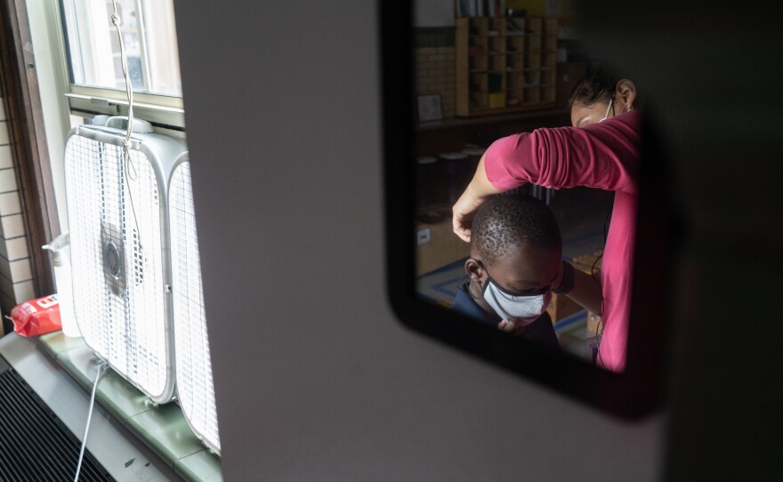 Quesada spends some class time helping students adjust their masks or replacing them if they need new ones.