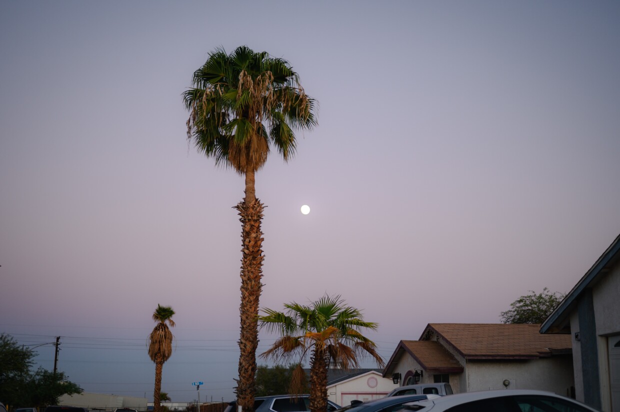 The moon rises above a neighborhood in El Centro, California in Imperial County on Oct. 15, 2024.