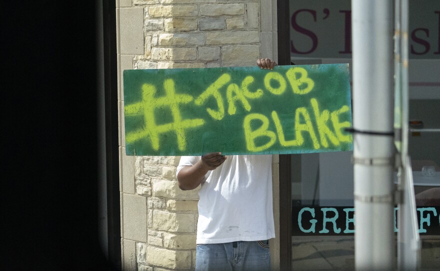 A Jacob Blake sign was on display as the motorcade of then-presidential candidate Joe Biden passed by in Kenosha Wis., on Sept. 3, 2020. A team of attorneys representing Blake have filed an excessive force lawsuit against the officer who shot and paralyzed him in August.