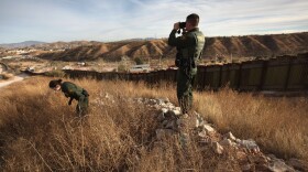 U.S. Border Patrol agents Richard Funke and Colleen Agle look for illegal immigrants crossing the U.S.- Mexico border on December 7, 2010 near Nogales, Arizona. 