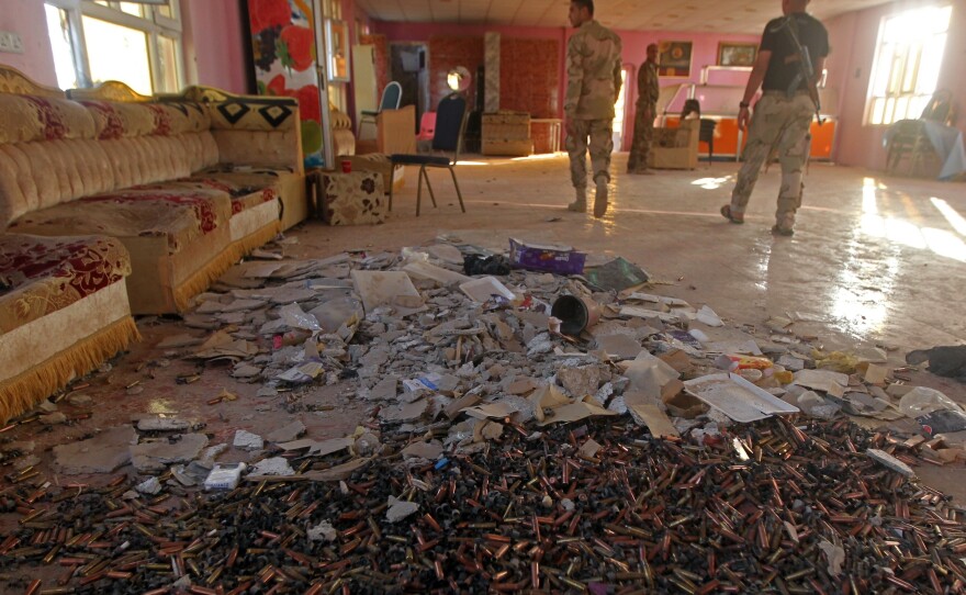 Iraqi Sunni fighters secure an area during clashes with ISIS fighters in Dhuluiyah.