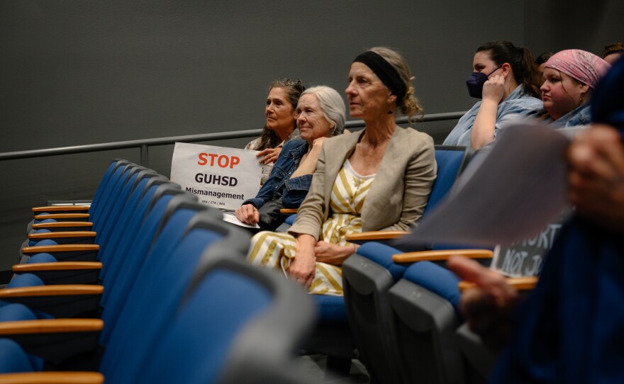 Retired Grossmont College Dean Janet Castaños holds a sign reading "STOP GUHSD Mismanagement" during a Grossmont Union High School District governing board meeting at Grossmont High School in El Cajon, California on Oct. 9, 2025. The board discussed several controversial issues, including proposals on religious expression in schools, library leadership changes and rules regarding protests at board meetings.