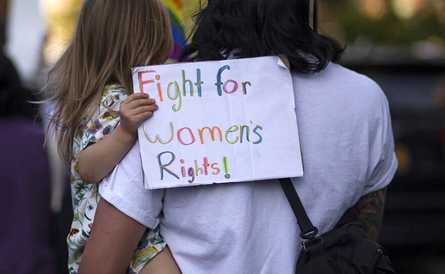 A girl holds a placard as protesters take part in the Women's March and Rally for Abortion Justice in New York, on October 2, 2021.
