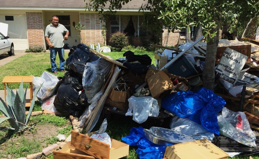 Salvador Cortez, surveys debris in his front yard in Houston after Hurricane Harvey last year.