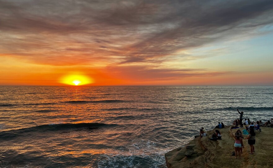 People watch the sunset on Sept. 5, 2024 at Sunset Cliffs in San Diego, Calif.