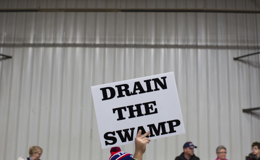 Supporters of then-Republican presidential candidate Donald Trump hold signs during a campaign rally in 2016 in Springfield, Ohio. Trump campaigned on a promise to "drain the swamp" of lobbyists and special interests — though Washington's influence industry remained during his administration.
