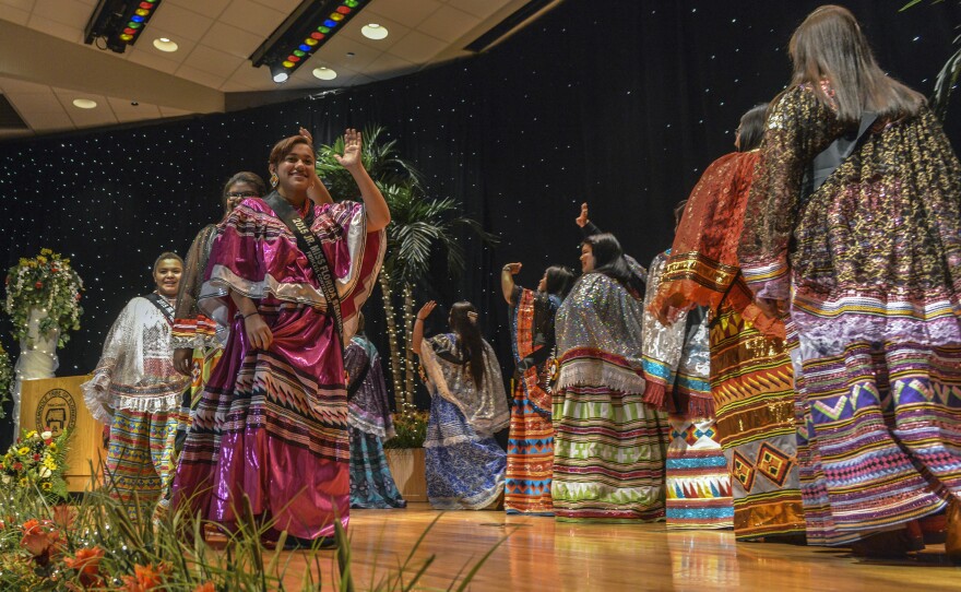 All twelve contestants in the Miss Florida Seminole Princess Pageant and Junior Miss Florida Seminole Princess Pageant, promenade across the stage, resplendent in their hand made patchwork garments.
