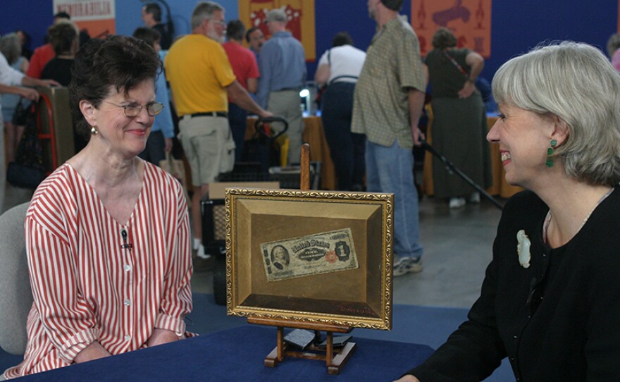 Colleene Fesko (right) appraises a Victor Dubreuil oil painting, ca. 1891, in Reno, Nev. 