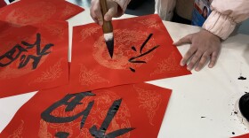 At the Main Media Center, the central hub for press, volunteers offered passersby the opportunity to paint calligraphy onto traditional New Year couplets.