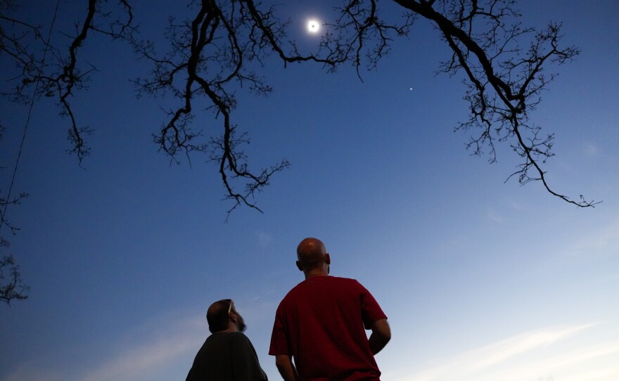 Spectators watch the solar eclipse at Cole Memorial Park in Chester, Ill.