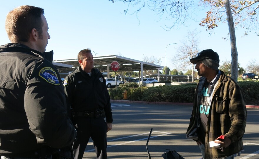 Officers Colin Lewis and Brad Smith (center) on patrol near a park in Huntington Beach, Calif. The area has seen a sharp increase in homelessness and petty thefts, which the officers blame on Proposition 47. But the law's supporters say other California cities have seen declines in property crime.