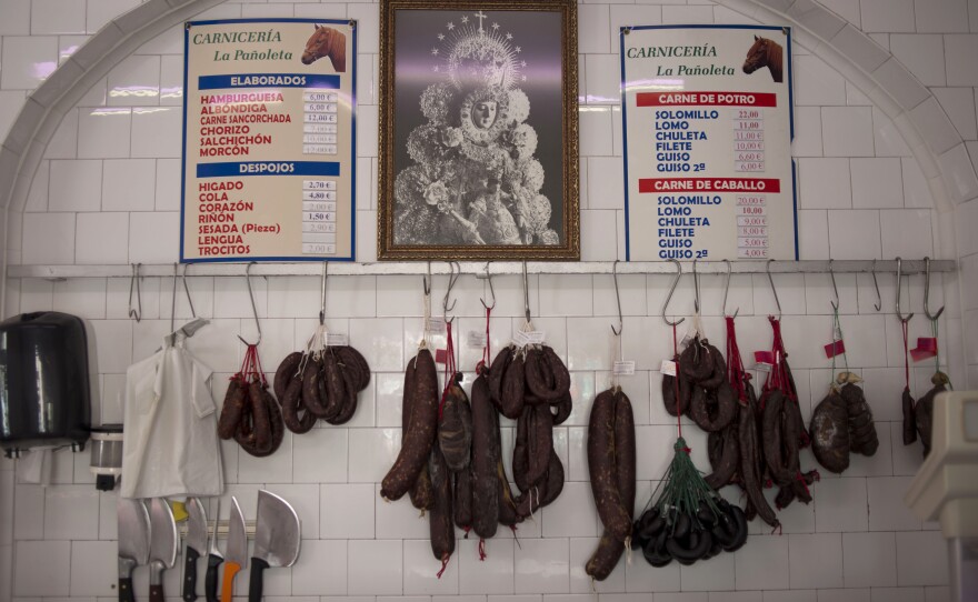 Cured sausage meats from horses hang in a horse butcher in Camas, Spain.