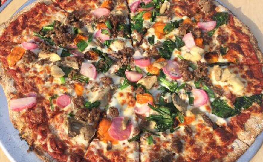 Five veggie (roasted radishes, broccoli raab, mixed farm mushrooms, scallions and cherry tomatoes) with sausage pizza from Stoney Acres Farm.