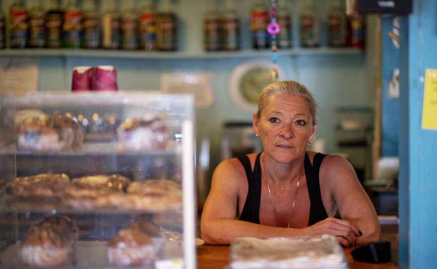 Heidi Richter works behind the counter at Caffe Aribac. Her customers include longtime locals, militia members, Border Patrol agents, and volunteers for the humanitarian groups that leave food and water for border-crossers out in the desert.