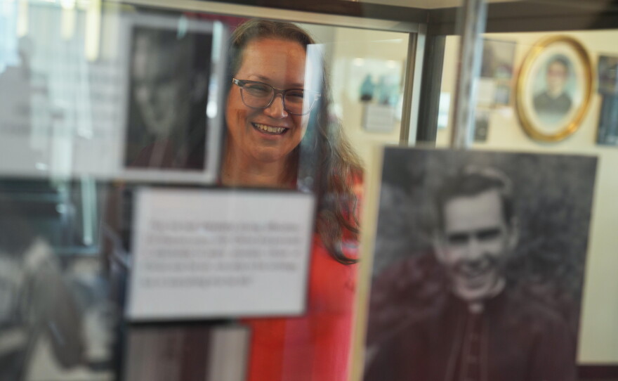 Bonnie Engstrom, who believes the late Archbishop Fulton Sheen helped save her son's life after he was born in 2010 without a pulse, looks at a photo of Sheen on display at the Sheen Museum in Peoria, Ill., on July 16, 2026.
