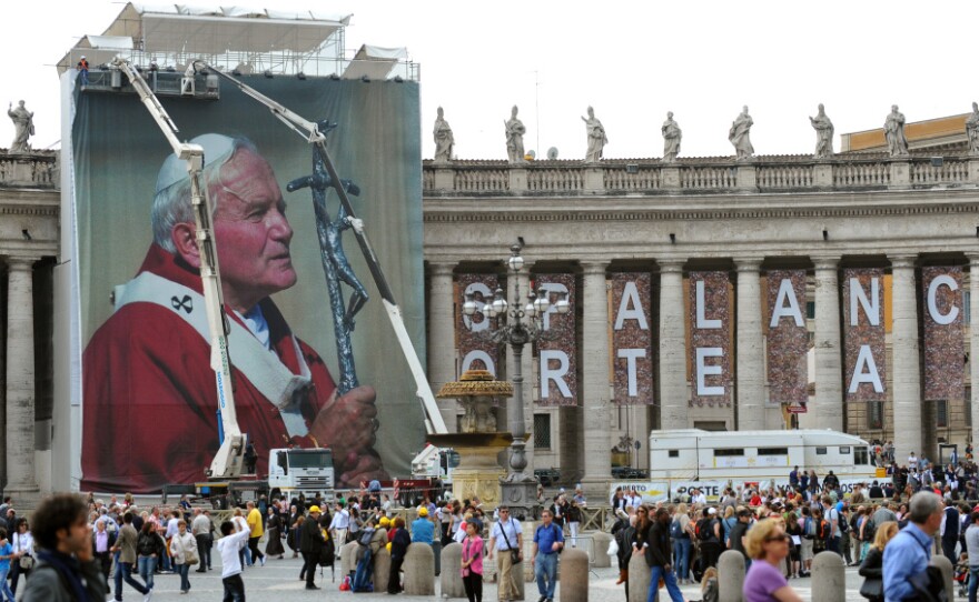 Workers set up a giant photo of the late Pope John Paul II at St. Peter's Square on April 27 at the Vatican. John Paul II will be honored May 1 at a beatification ceremony.