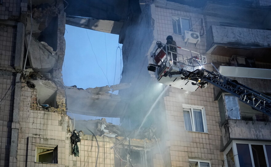 Rescuers work the scene of a building damaged by Russian missile attack in Kyiv, Ukraine, Monday, July 6, 2026.