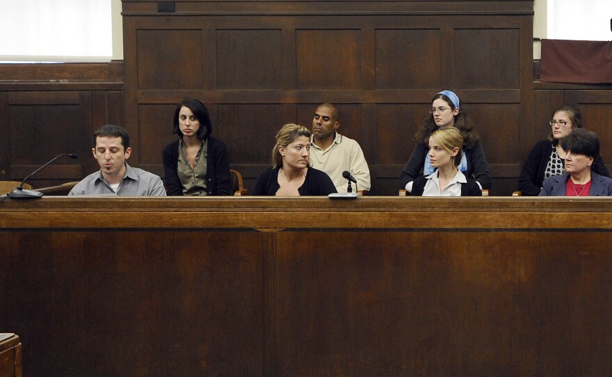 The jury sits in the jury box as foreman Michael Gregory, left, issues a statement in June 2009 after announcing a kidnapping conviction in Suffolk Superior Court in Boston.