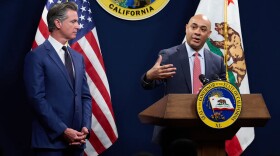 Gov. Gavin Newsom, left, listens as Joe Stephenshaw, director of the Department of Finance, speaks during a press conference unveiling Newsom's revised 2024-25 budget proposal at the Capitol Annex Swing Space in Sacramento on May 10, 2024.