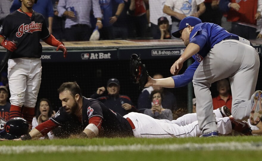 The Cleveland Indians' Jason Kipnis scores, evading a tag by the Chicago Cubs' Jon Lester during the fifth inning of World Series Game 7 on Wednesday.