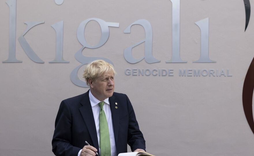 British Prime Minister Boris Johnson signs the visitors book while visiting the Kigali Genocide Memorial in Kigali, Rwanda, Thursday June 23, 2022.