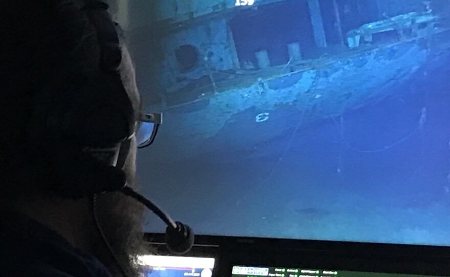 A researcher examines the underwater hull of the USS Hornet CV-8, which played a role in several key events of World War II.