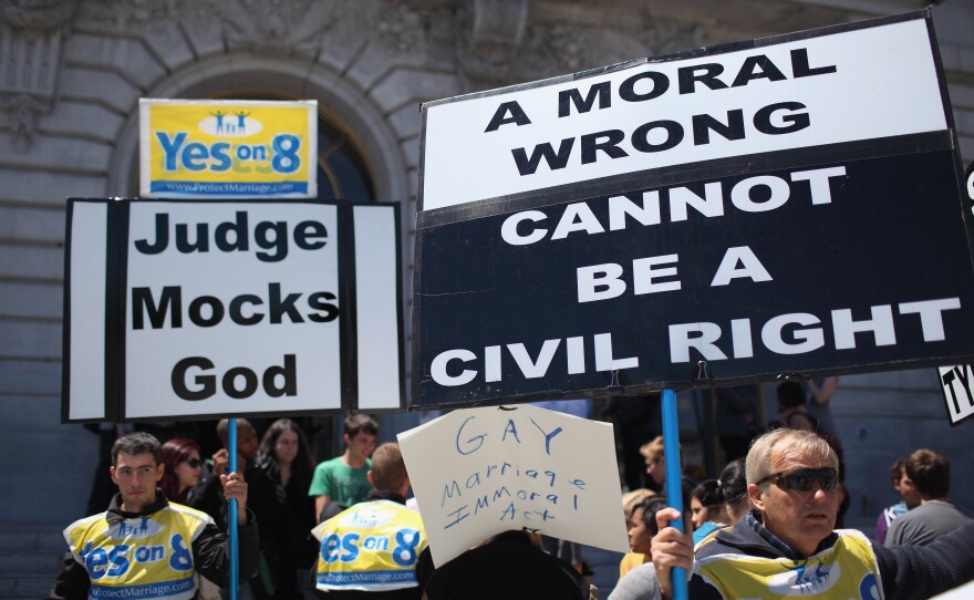 Opponents of same-sex hold signs outside of San Francisco city hall after a decision to lift a stay on same-sex marriages was announced August 12, 2010 in San Francisco, California.