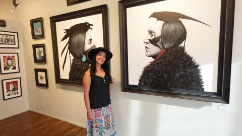 Owner of Exclusive Collections Gallery, Ruth Ann Thorn, in front of art by a Native American for Native American Heritage Month on Nov. 10th.