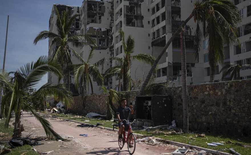 <strong>Oct. 29:</strong> A man rides at a damaged zone in the aftermath of Hurricane Otis in Acapulco, Mexico.