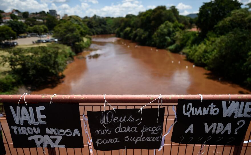 Residents and relatives of victims place messages on the bridge over the Paraopeba River, during a tribute to those who died after a tailings dam collapsed in the town of Brumadinho, Brazil.