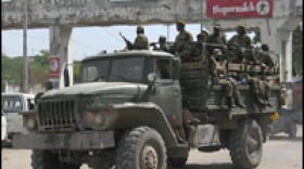 An Ethiopian army truck belonging to the first batch of troops leaving Mogadishu drives through the bullet-riddled "Arch of the People's Triumph."